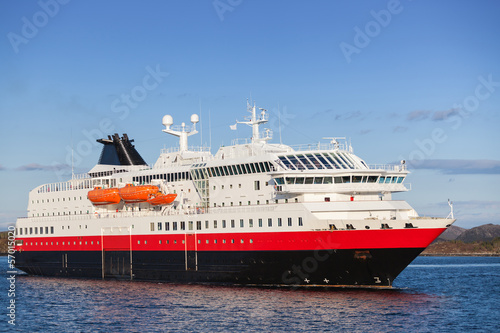 Big Norwegian passenger cruise ship goes on fjord © evannovostro
