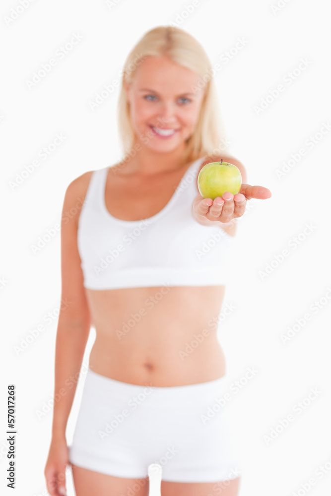 Charming blond woman holding an apple Charming blond woman holding an apple
