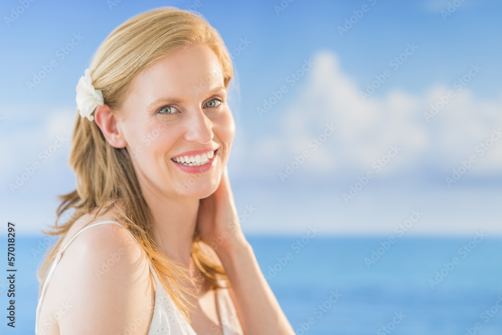 Woman Smiling Against Sea At Beach