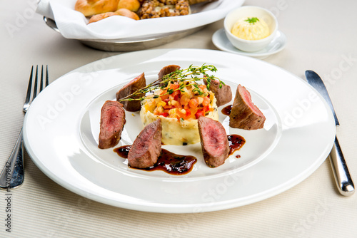 Beef and mashed potatoes decorated with vegetables