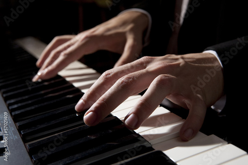 Male hands playing piano