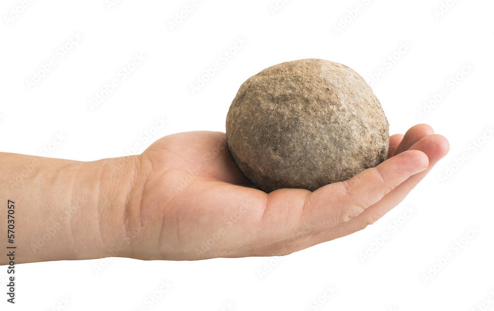Hand holding stone ball