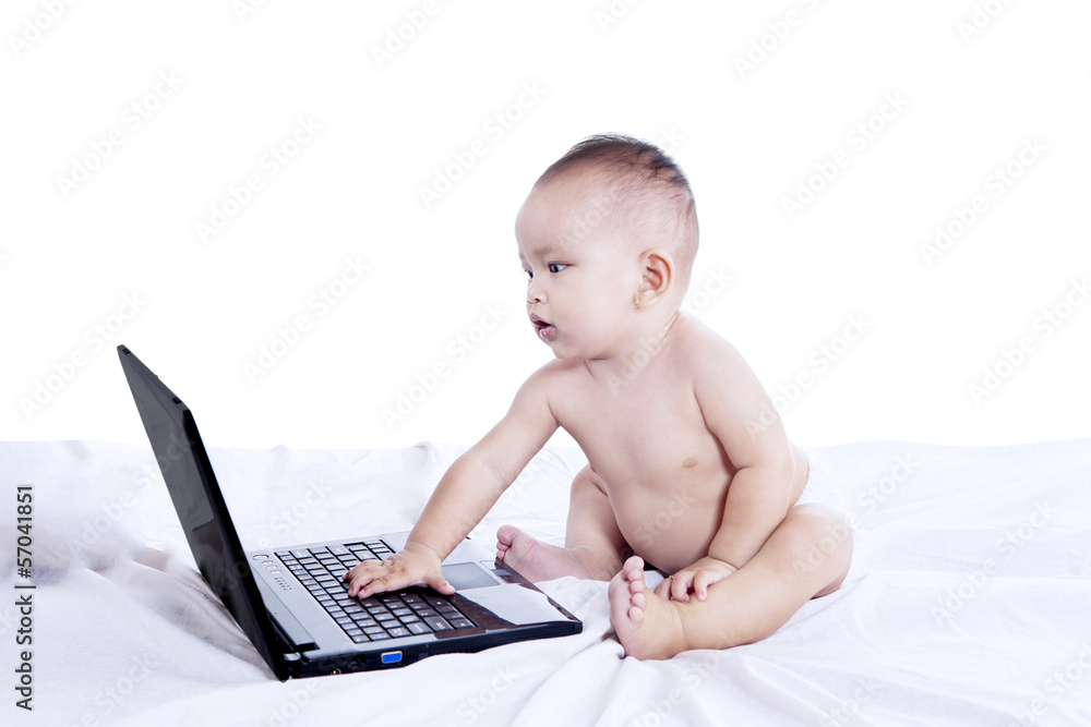 Little baby and laptop computer Little baby and laptop computer