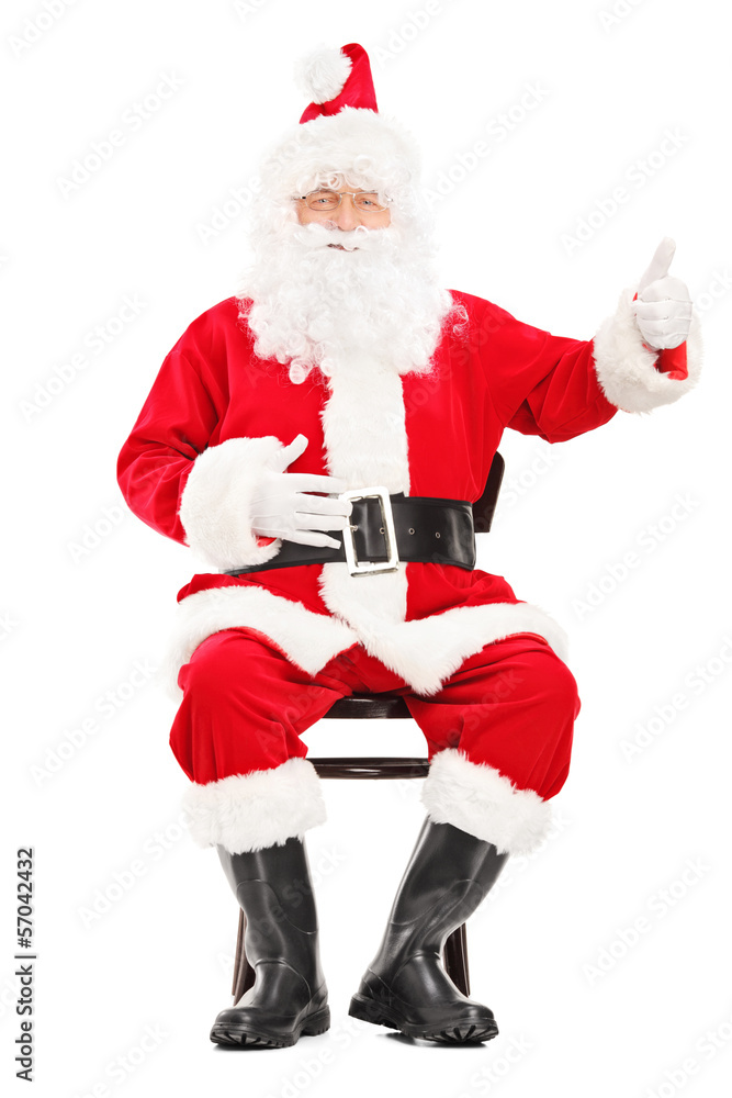 Happy Santa claus sitting on a chair and giving a thumb up Happy Santa claus sitting on a chair and giving a thumb up