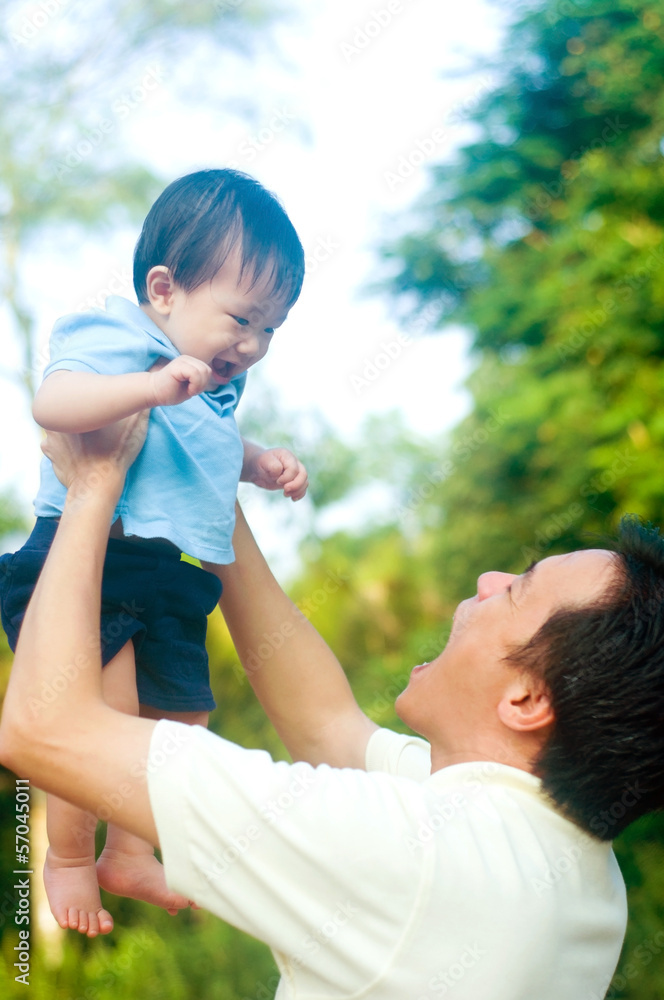 Asian father playing with baby boy Asian father playing with baby boy