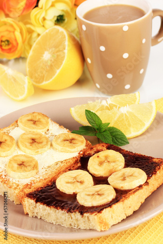 Delicious toast with bananas on plate close-up