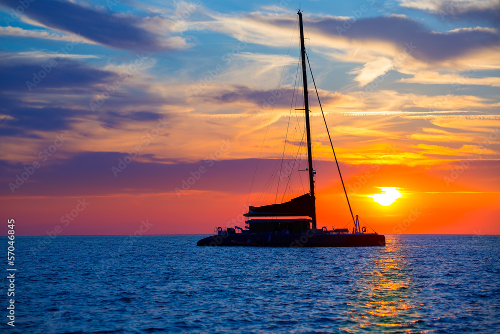 Ibiza san Antonio Abad catamaran sailboat sunset - obrazy, fototapety, plakaty 