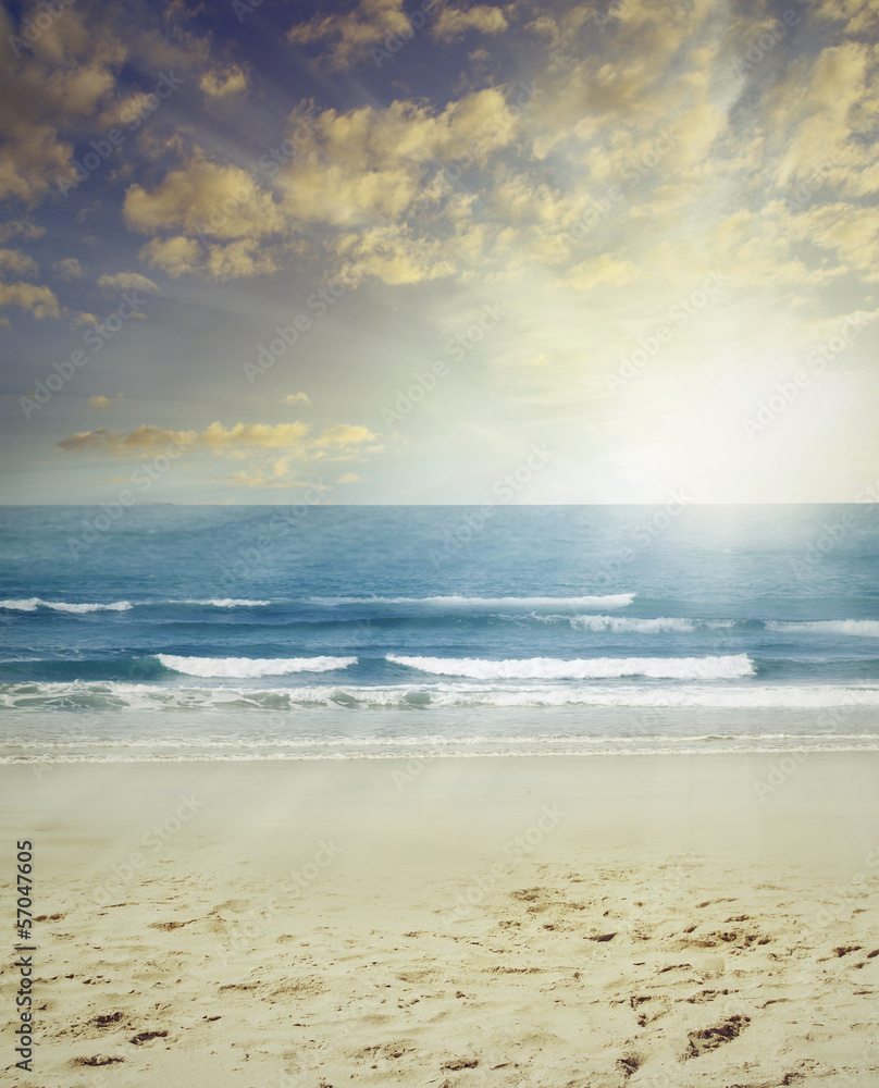 Sand sea and sun in sky beach scene
