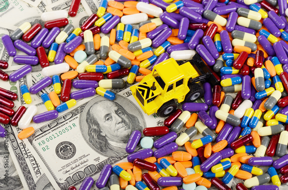 Fototapeta premium Industrial tractor toy rake up tablets and pills