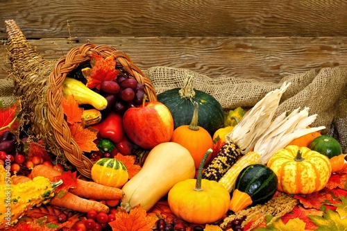 Harvest or Thanksgiving cornucopia filled with vegetables photo