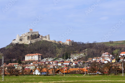 Old gothic stronghold overwatching village photo