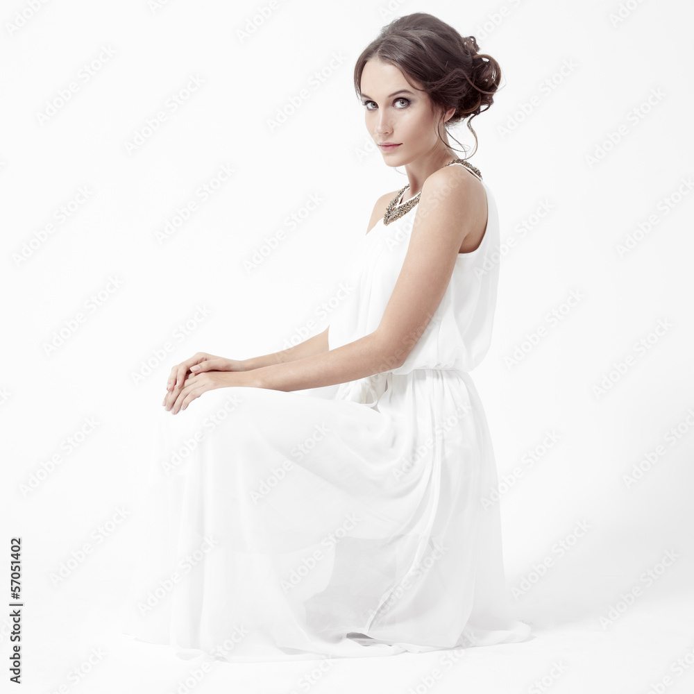 Young brunette woman in white dress. White Background. Young brunette woman in white dress. White Background.