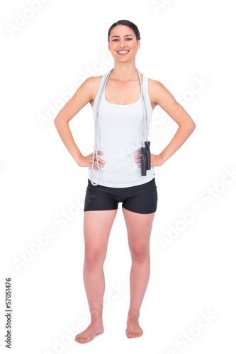 Cheerful slender model with her jump rope on shoulders