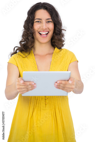 Happy casual young woman holding her tablet computer