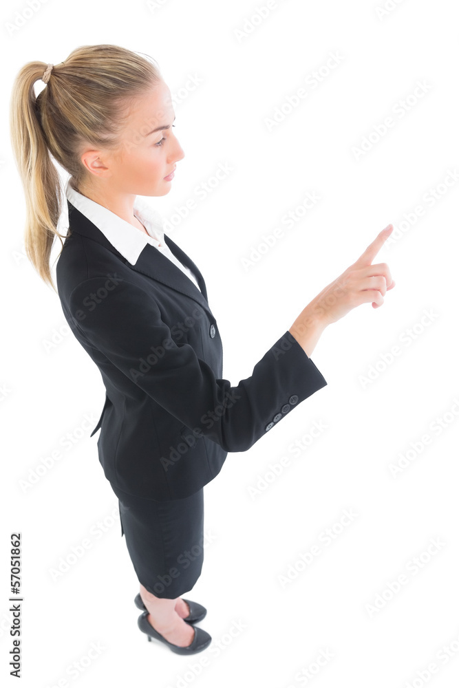High angle profile view of young businesswoman pointing upwards High angle profile view of young businesswoman pointing upwards