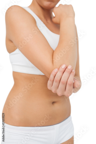 Suffering woman touching her sore elbow © WavebreakmediaMicro