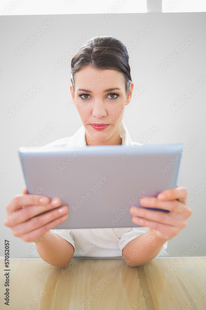 Serious businesswoman working on tablet pc Serious businesswoman working on tablet pc