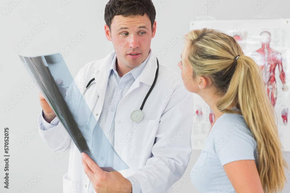 Concerned doctor showing a patient something on x-ray