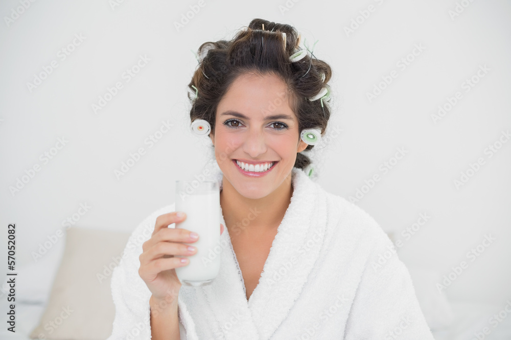 Happy natural brunette holding glass of milk Happy natural brunette holding glass of milk