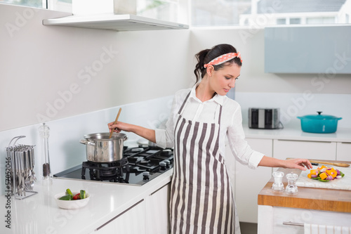 Peaceful pretty woman with apron cooking