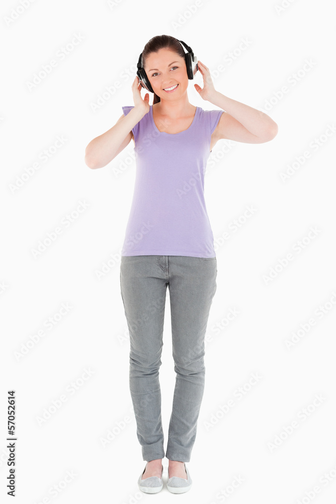 Attractive woman posing with headphones while standing Attractive woman posing with headphones while standing