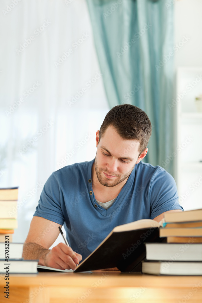 Male student preparing book report Male student preparing book report