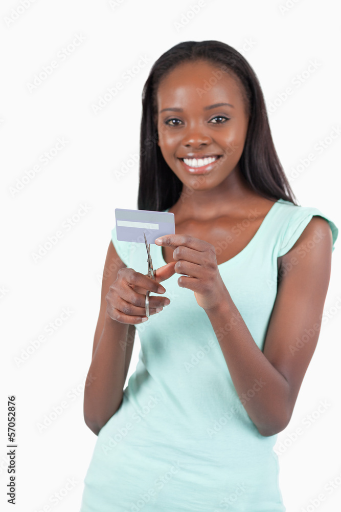 Happy smiling young woman destroying credit card Happy smiling young woman destroying credit card