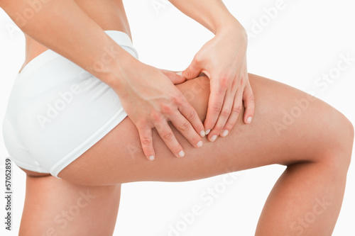 Woman touching her thigh