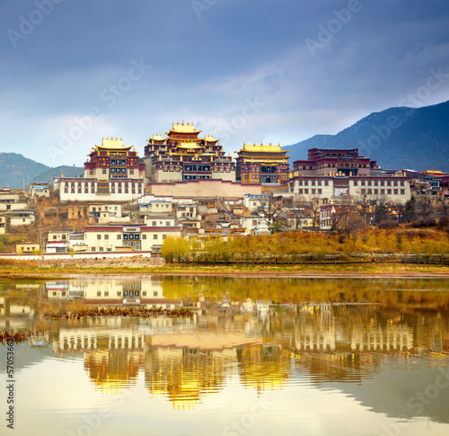 Landscape with tibetan monastery and lake