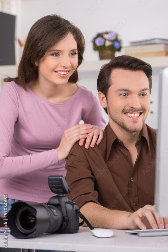 Two people are seating by computer. Two people are seating by computer.