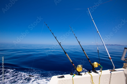 Ibiza fishing boat trolling rods and reels in blue sea