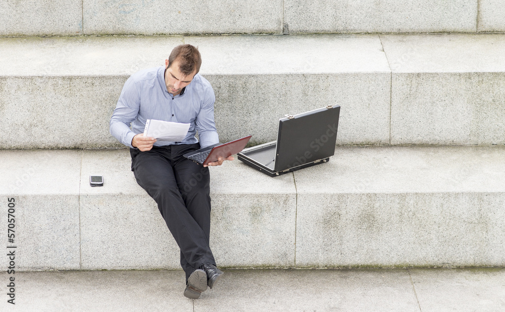 Businessman sitting on the steps and working with computer. Businessman sitting on the steps and working with computer.