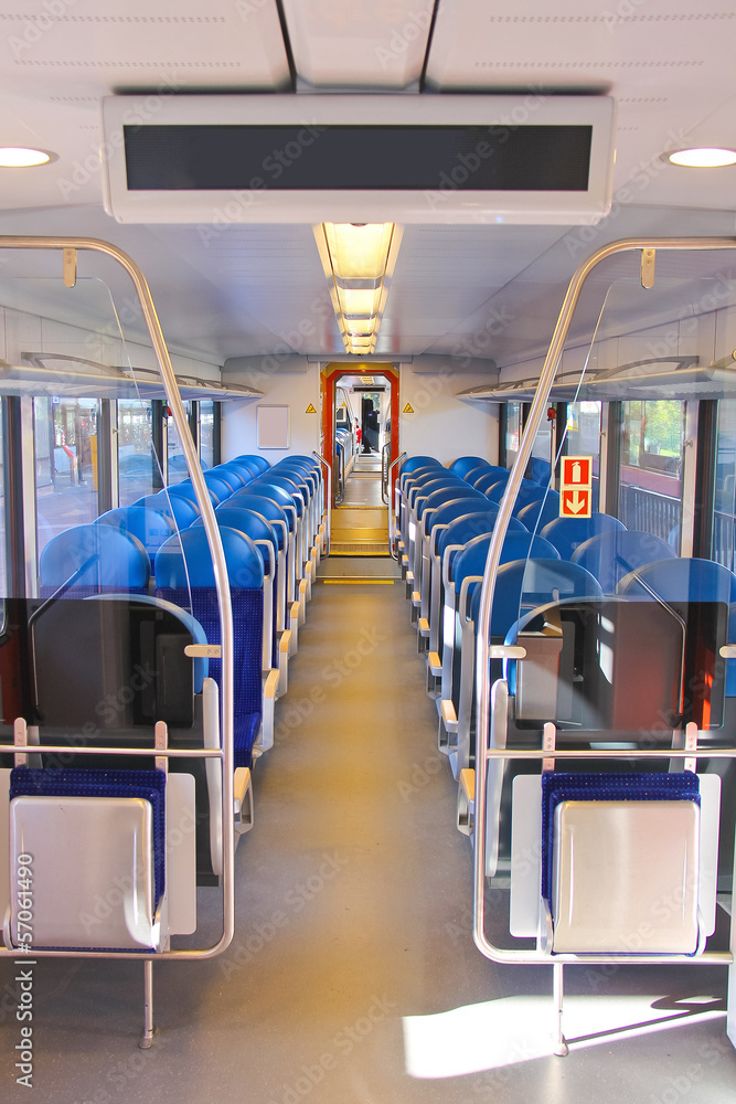 Fototapeta premium Rows of seats in a passenger train car.