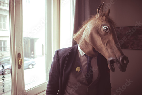 horse mask man in front of window