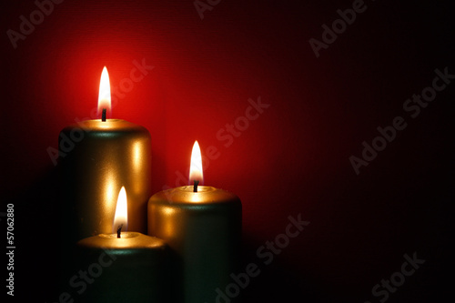 Three burning gold candles