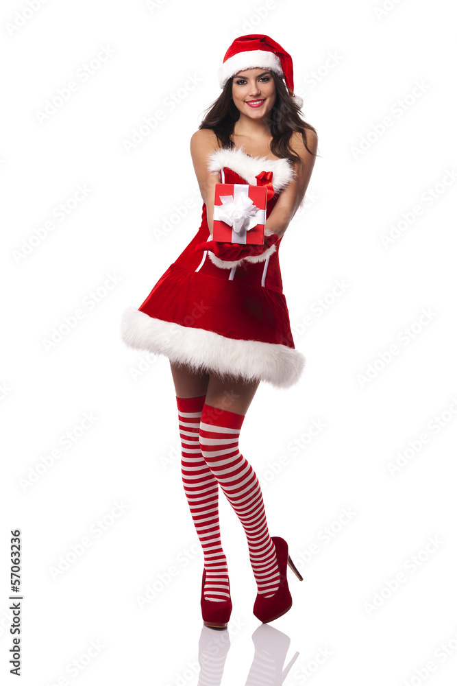 Smiling santa claus woman giving red christmas gift Smiling santa claus woman giving red christmas gift
