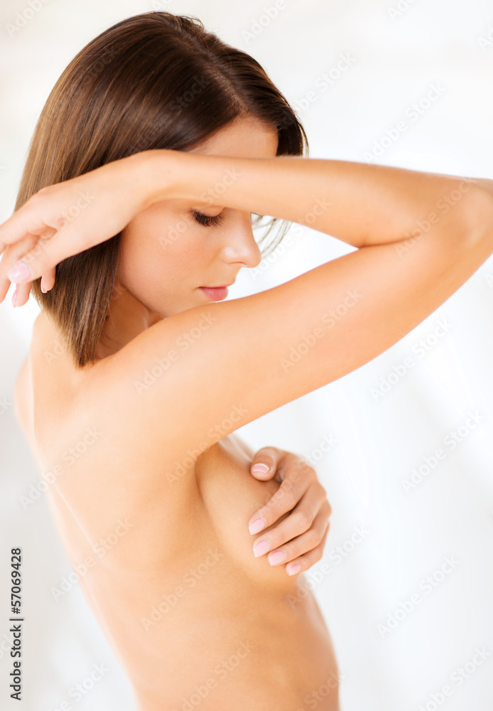 Fototapeta premium woman checking breast for signs of cancer