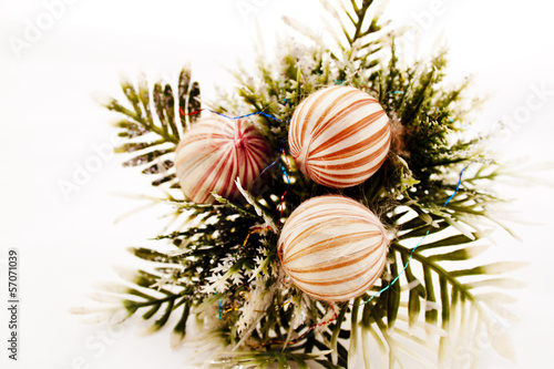 Three Decorative Baubles On Sprig Of Leaves
