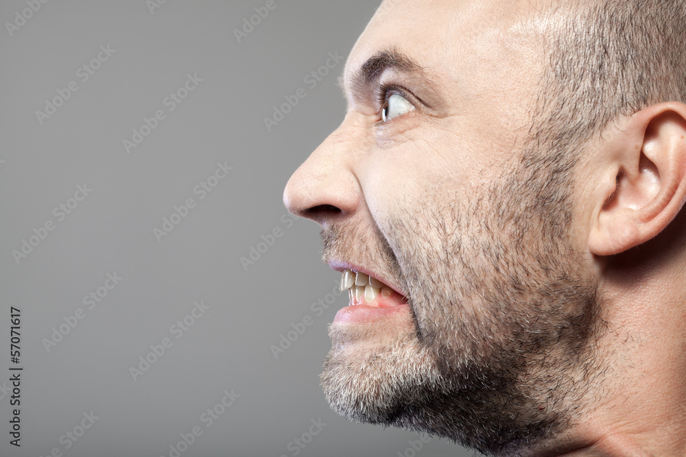portrait of angry man isolated on gray background with copyspace portrait of angry man isolated on gray background with copyspace