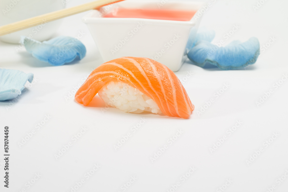 Salmon sushi nigiri with chopsticks and orange sauce
