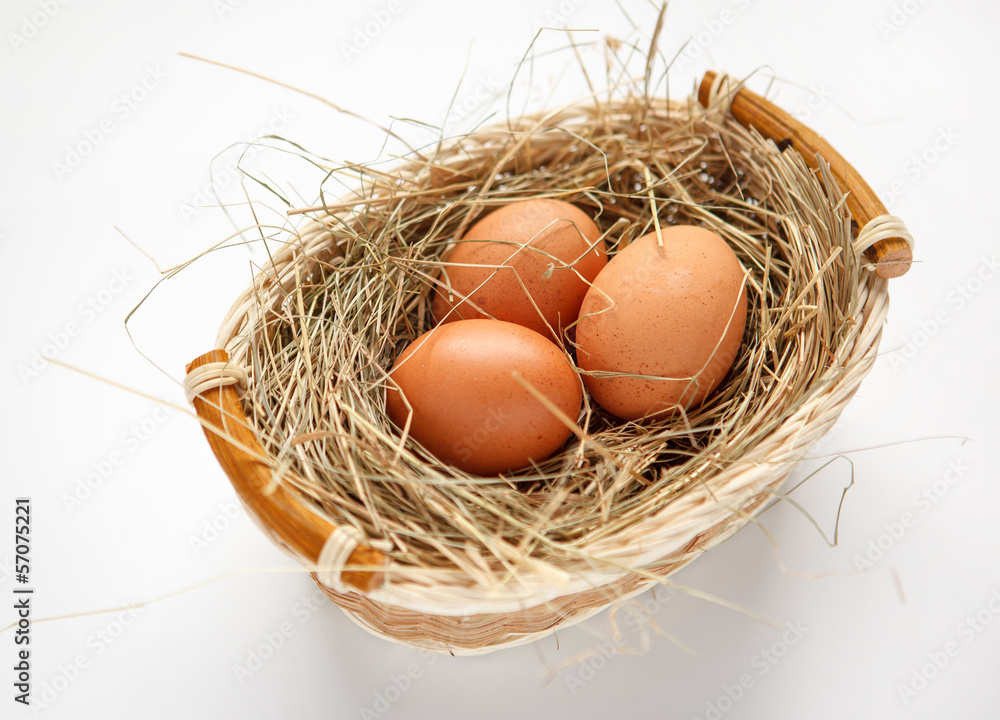 Wattled willow basket with brown chicken eggs Wattled willow basket with brown chicken eggs