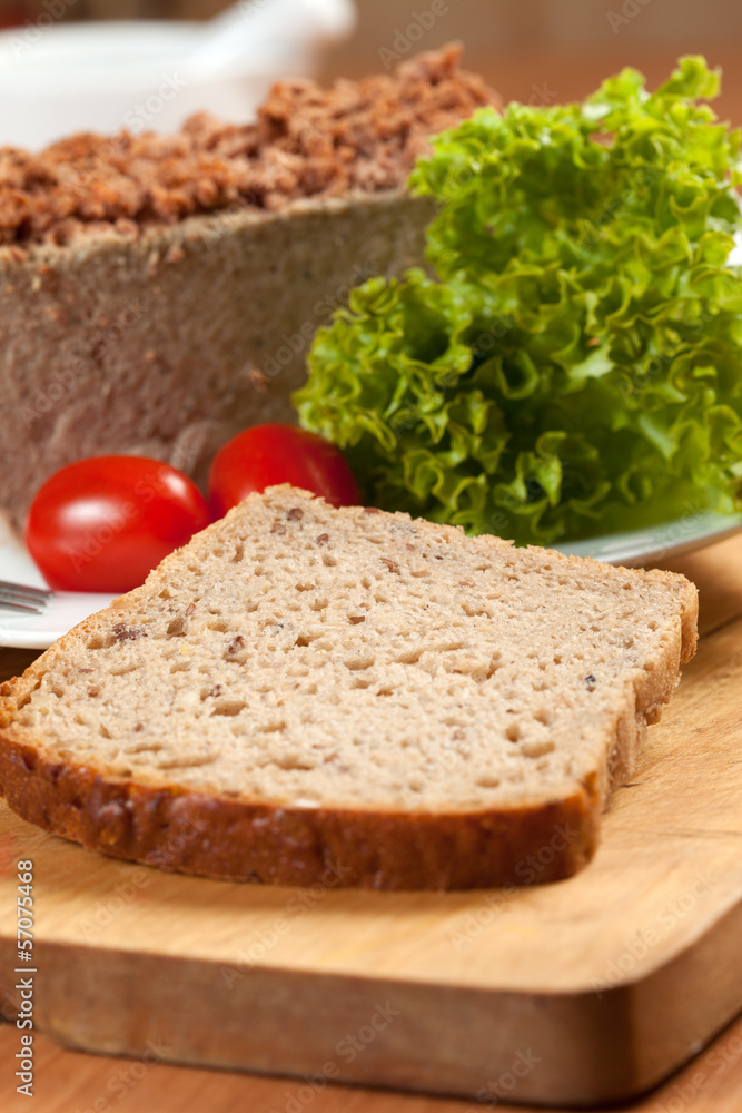 Venison pate on a plate decorated with salad. Venison pate on a plate decorated with salad.