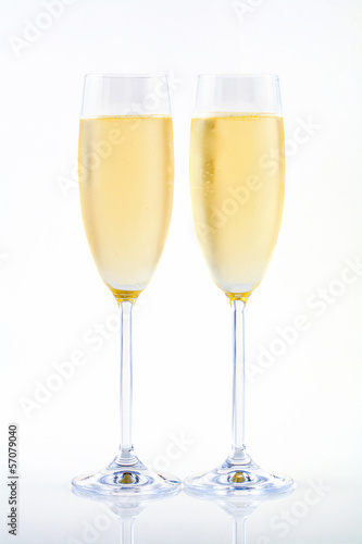 Two glasses of champagne on white