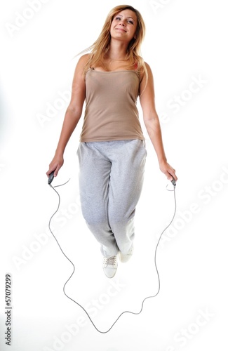 young fitness woman with jump rope isolated