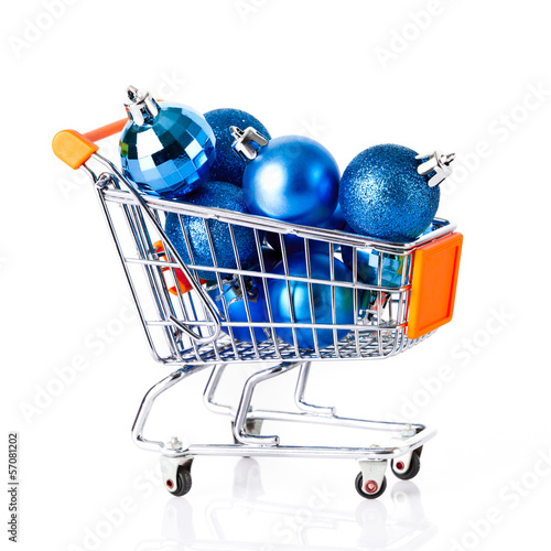 Shopping cart full of christmas balls isolated on white backgrou