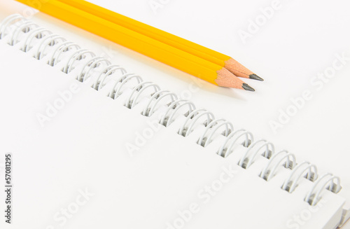 Notebook and yellow pencil
