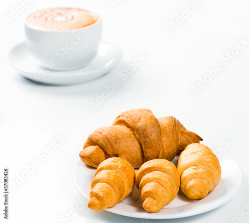 croissants on a plate and a cup of coffee