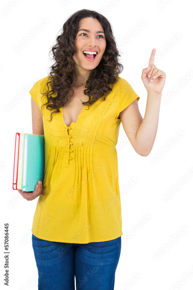 Happy curly haired student holding notebooks Happy curly haired student holding notebooks