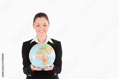 Good looking woman in suit holding a globe