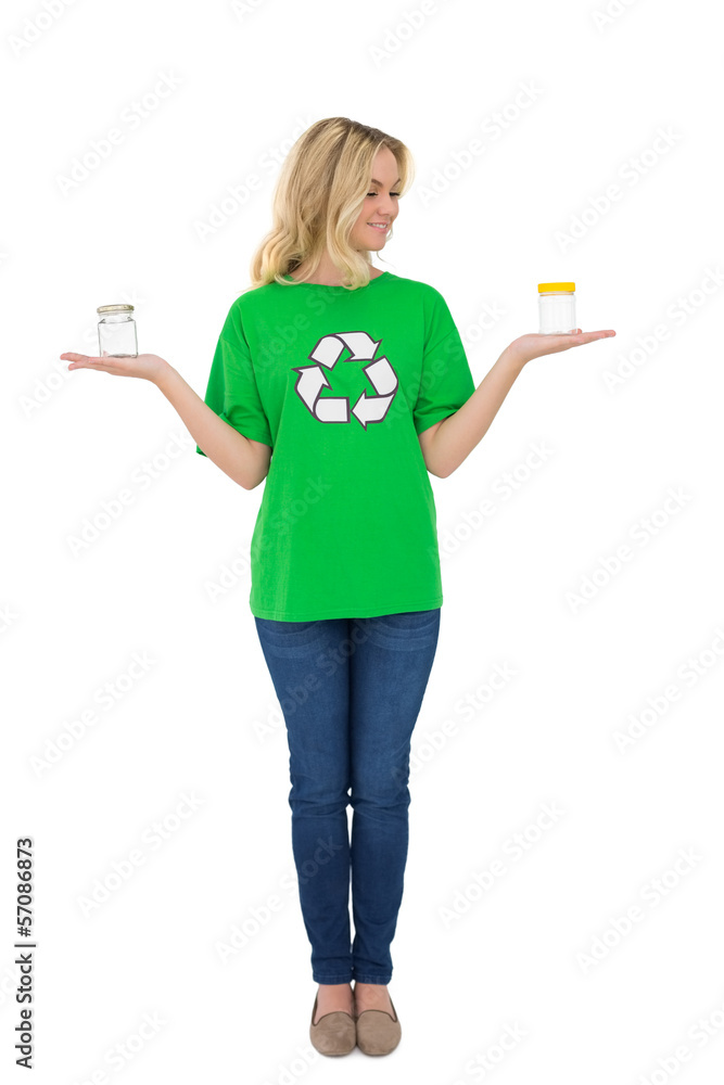 Happy cute environmental activist holding glass jars Happy cute environmental activist holding glass jars
